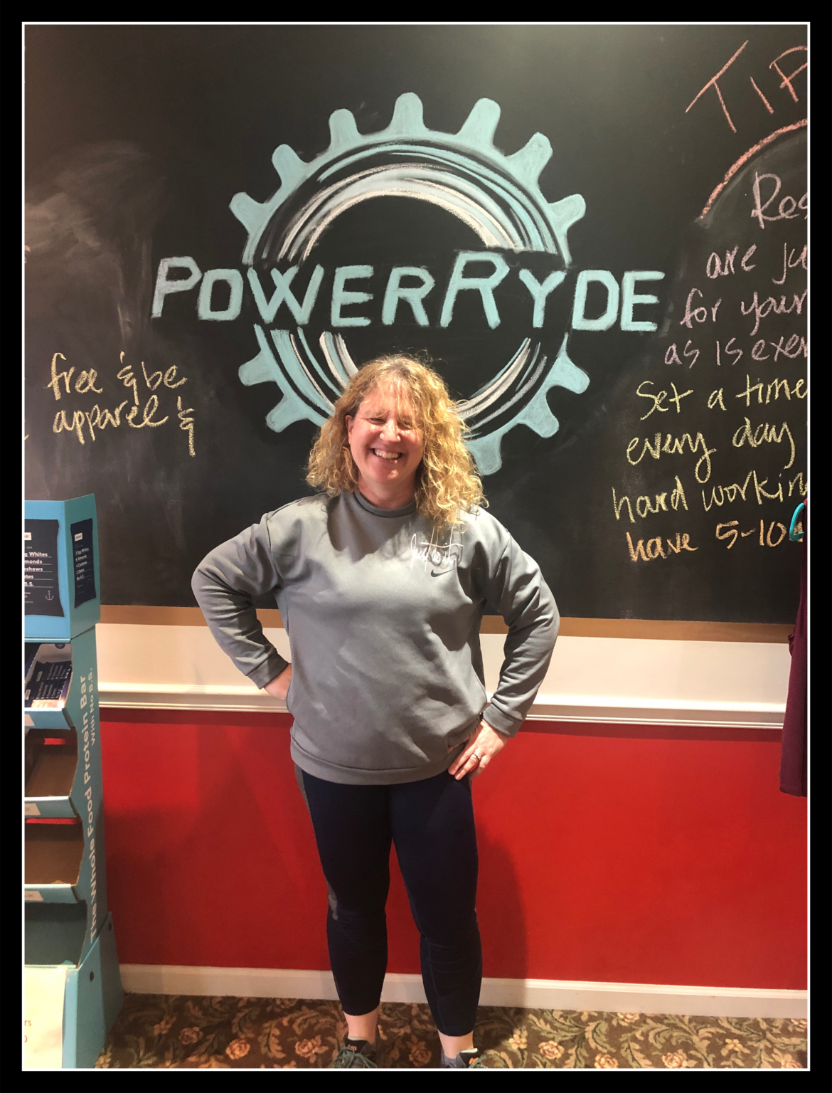 Michele Kelley in front of chalk PowerRyde logo