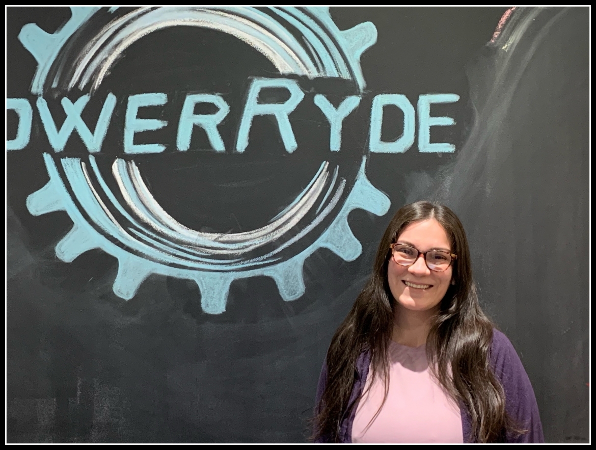 Adriana Rodriguez in front of PowerRyde chalk board